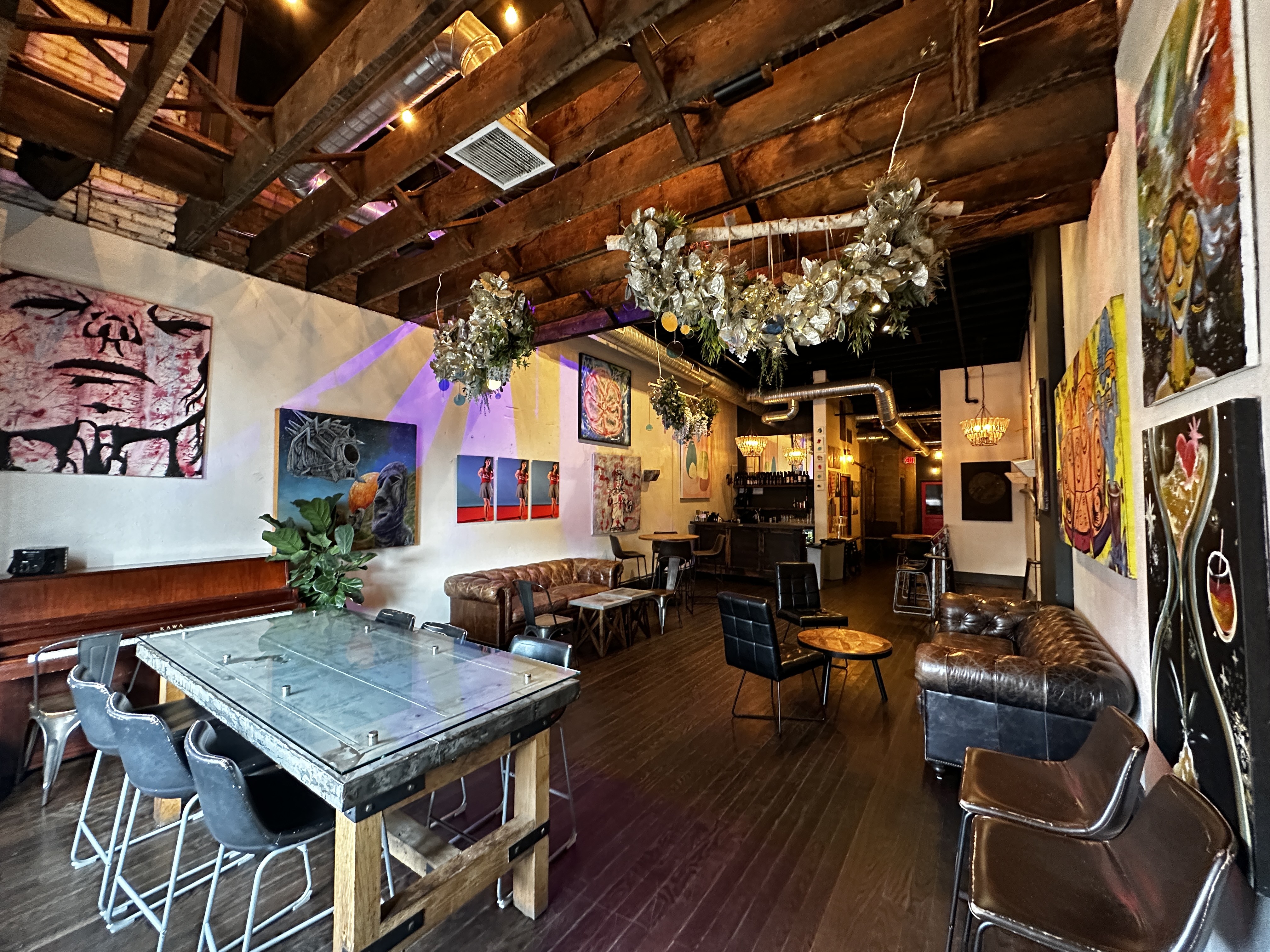 Revel OTR second-floor event space with lounge seating, local art, and the bar