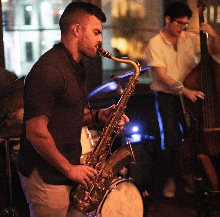 Saxophone and upright bass duo playing a set at Revel OTR