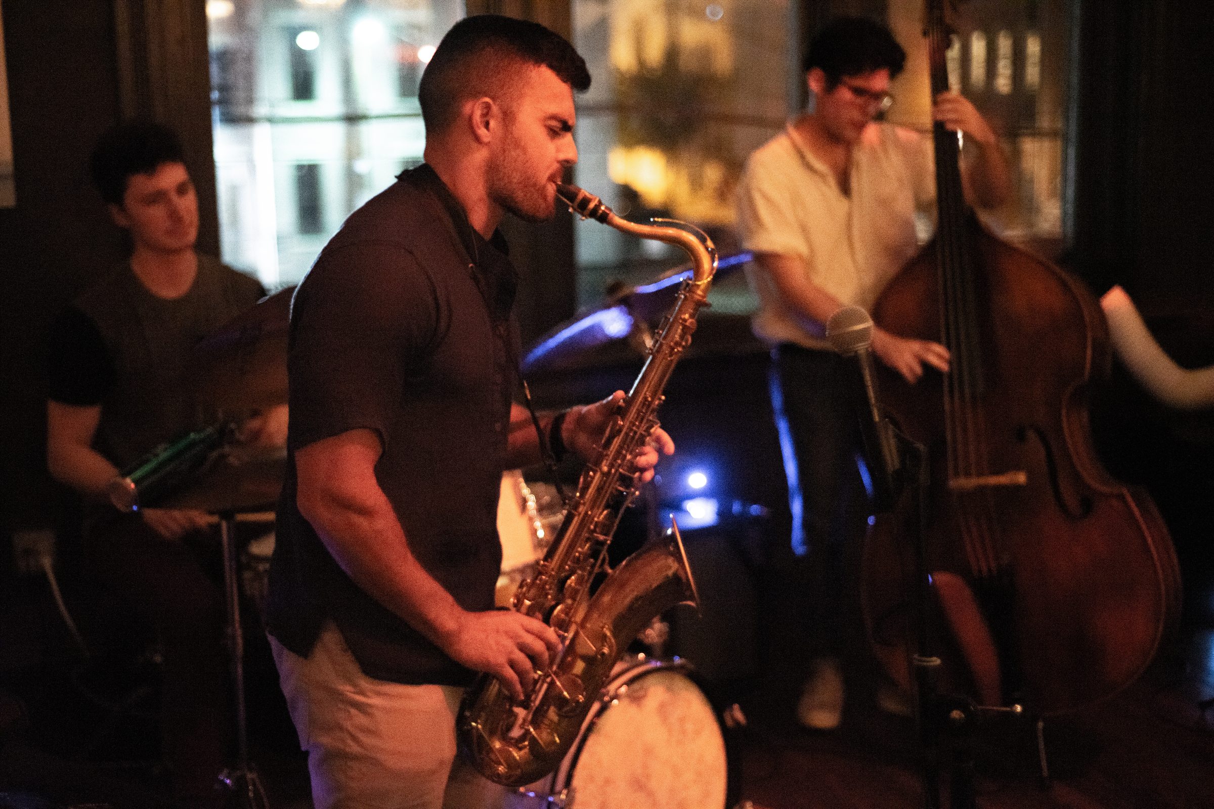 Jazz trio with saxophone, drums, and upright bass at Revel OTR